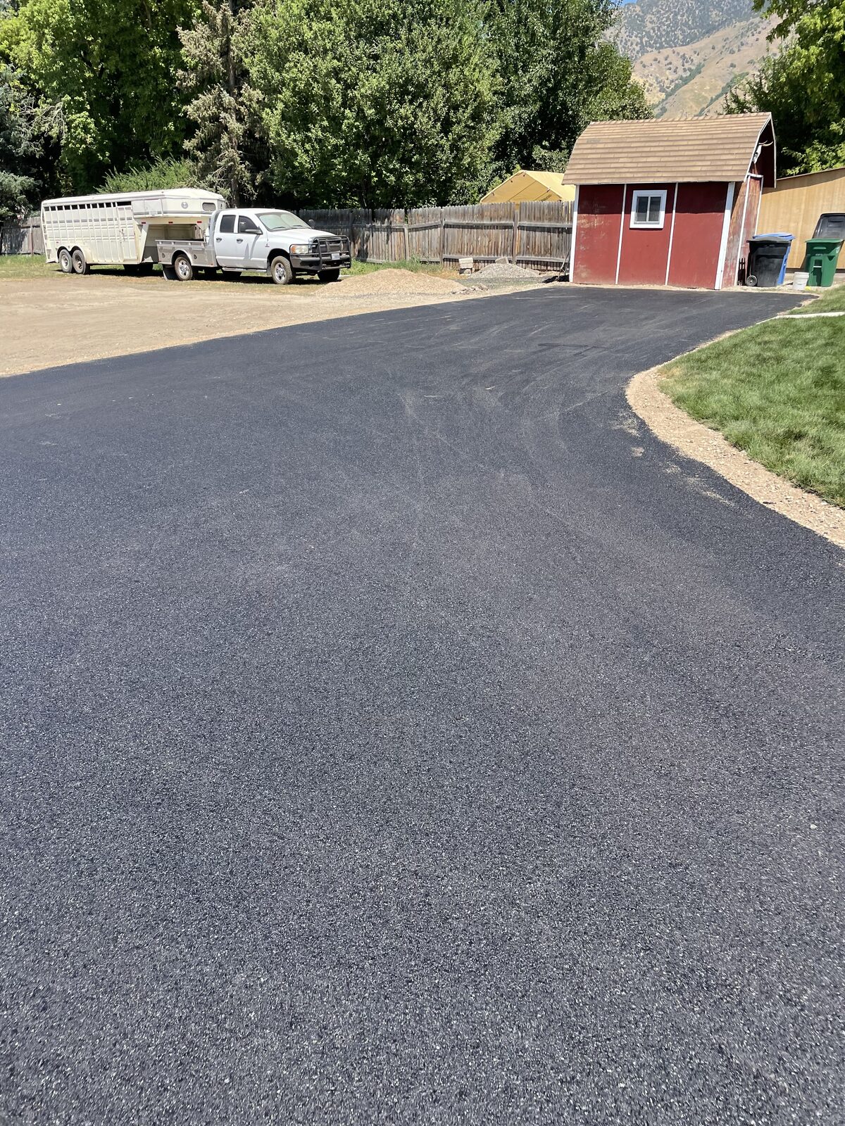 A freshly repaired and sealed asphalt driveway at a rural Utah home along the Wasatch Front in fall
